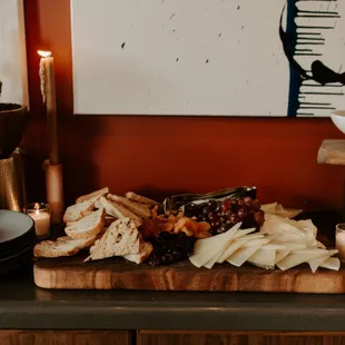 a platter of cheese, crackers, and other foods