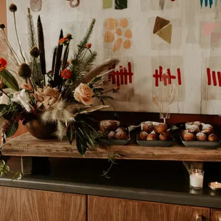 a table with cupcakes and flowers