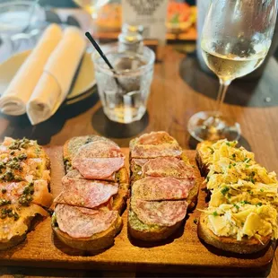 Assorted bruschetta board: Smoked salmon/pesto, salami/pesto (2), warm artichoke spread