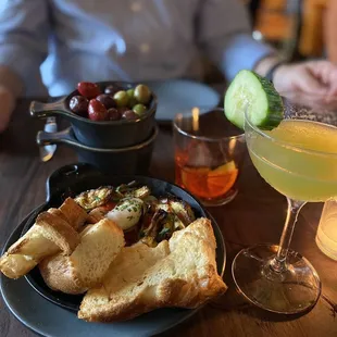 Shrimp scampi, olives, cucumber cocktail and negroni