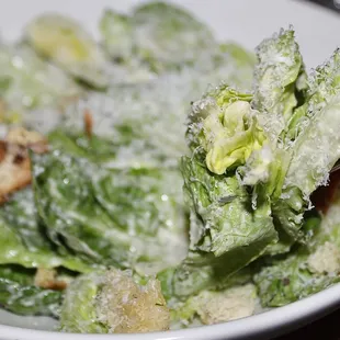 The Caesar Salad is made with baby gem lettuce, parmigiano-reggiano, house crouton, &amp; garlic dressing.