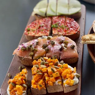 Bruschetta Board Brie Fig Apple, Spicy Pepper Goat Cheese, Salmon Pesto, Seasonal: Butternut Squash Goat Cheese Pepitas