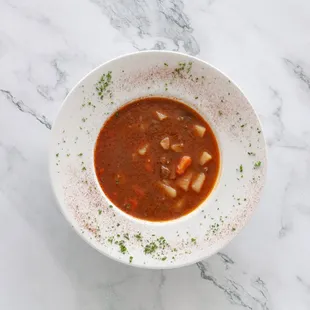 The FAMOUS Gulyás soup, traditional Hungarian Beef Soup with carrots, potatoes, parsnip and of course HUNGARIAN PAPRIKA.