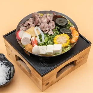  hot pot with meat, vegetables, and noodles
