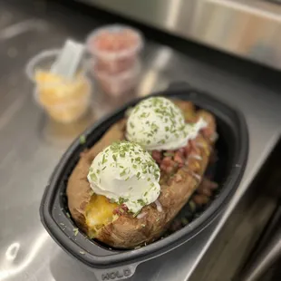 a closeup of a baked potato with sour cream and sour cream