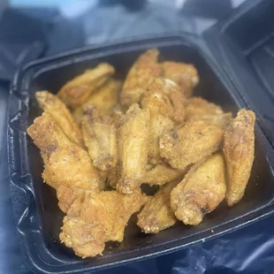 fried chicken wings in a plastic container