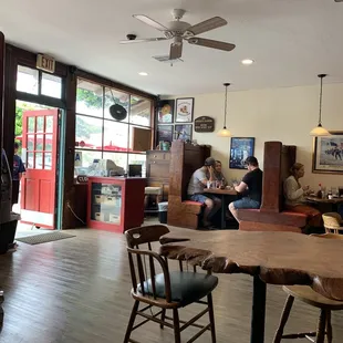 people sitting at tables in a restaurant