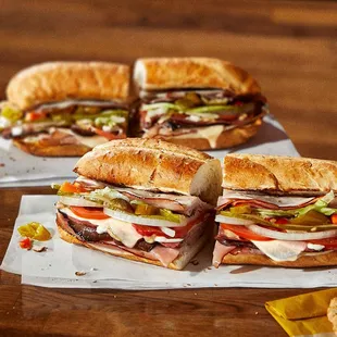 two sub sandwiches on a table