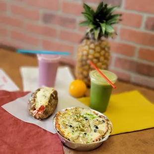 a pineapple and a pizza on a table