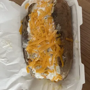 Giant baked potato with garlic sauce and all the cheese!