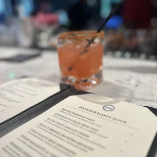 a drink and menu on a table