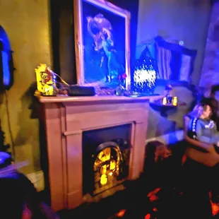 a man and a woman sitting in front of a fireplace