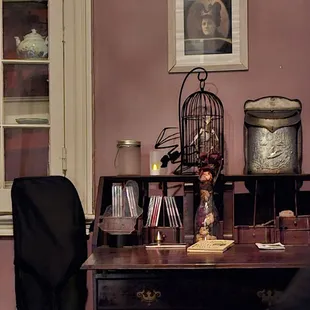 a desk with a birdcage on top of it