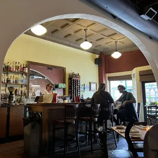 two people sitting at a bar