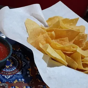 a bowl of chips and a bowl of salsa
