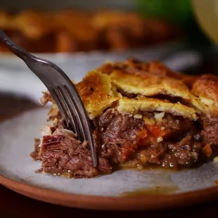 a piece of pie on a plate with a fork