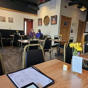 a woman sitting at a table in a restaurant