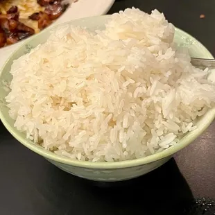 a bowl of rice and a plate of meat