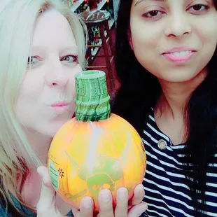 two women holding a pumpkin