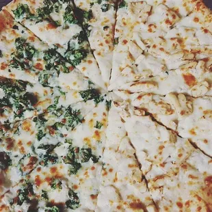 a pizza with cheese and spinach