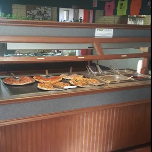 pizzas in a display case