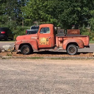 an old rusted truck in a parking lot