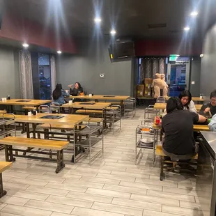 several people sitting at tables in a restaurant