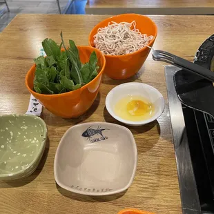 a variety of bowls of food on a table