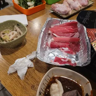 Baby bok choy, beef and lamb, dumplings, chicken wings, and lotus root
