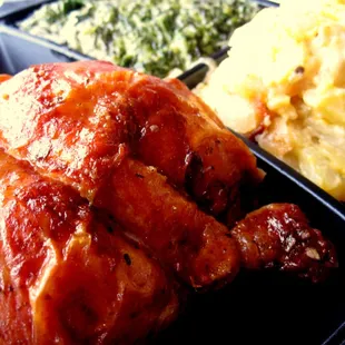 Rotisserie chicken leg quarter with creamed spinach, scalloped potatoes