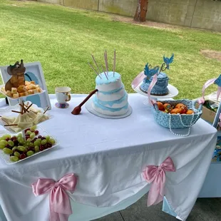 Beautiful smash cake and Topsy Turvy with broom made by Poul's Bakery.