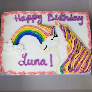 Unicorn cake with fondant golden horn and fondant mane.