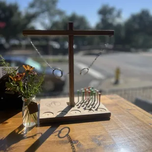 a cross on a table with a vase of flowers
