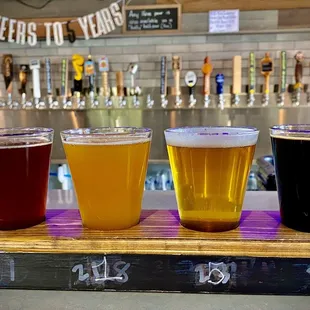 a row of beer glasses on a bar