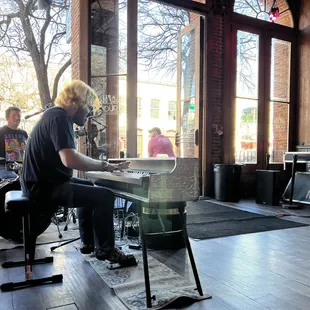 a man playing the piano in a music studio