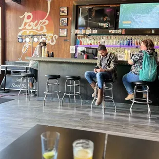 two people sitting at a bar