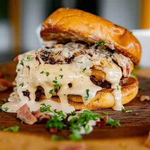 a cheeseburger on a wooden cutting board
