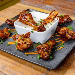 a plate of chicken wings with dipping sauce