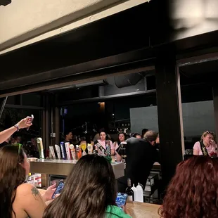 a man standing in front of a bar