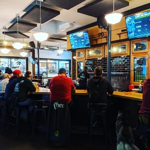 a group of people sitting at a bar