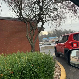 a red jeep parked in a parking lot