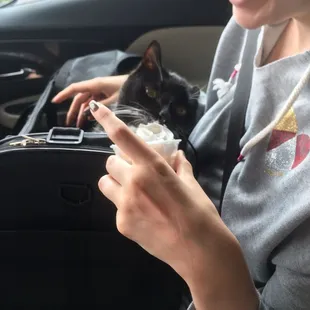 Hannah helping Fred enjoy his kitty cup.