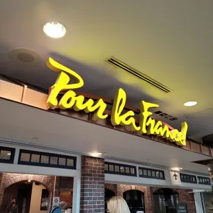 a woman standing in front of a restaurant