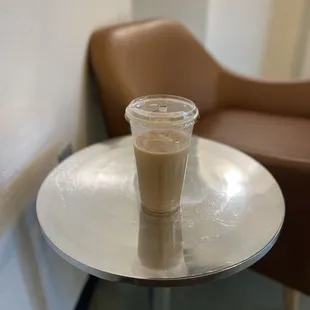 a glass of coffee on a table