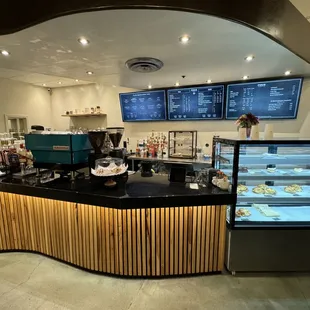 Pour My Coffee Co front service counter, food display case, and digital menus