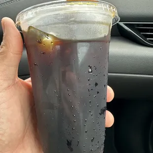 a hand holding a cup of coffee