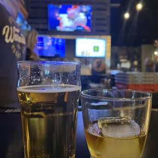 two glasses of beer on a bar