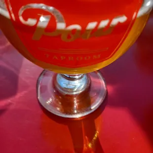 a glass of beer with ice