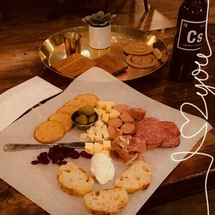 a platter of cheese, meat, and bread