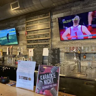 a bar with a television and menus